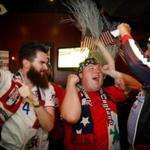 The Banshee in Dorchester is home to the Boston chapter of the soccer-loving American Outlaws, including (from left to right) Connor Steck, Tim Westfield, and Brian Ledet, who cheered a goal by the US men against Peru on Friday night.