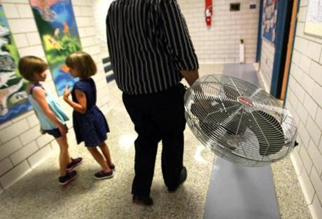 Officials sought to help cool students by delivering about 100 fans to schools around Boston Tuesday, including Joseph P. Manning Elementary School.
