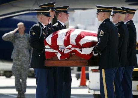 Members of the New Hampshire Army National Guard Honor Guard carried the remains of Korean War veteran Army Sgt. Christopher Vars at Logan Airport in Boston.
