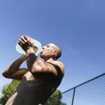 Arick Bell of Somerville drank water to stay hydrated while working out at the Dilboy Field playground in Medford.