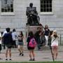 Visitors took photos by the John Harvard statue on Thursday.