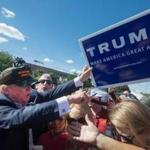 Donald Trump greeted supporters Saturday in Ames, Iowa. Football fans were tailgating outside the Iowa State-Iowa football game, and several Republican presidential candidates campaigned there.