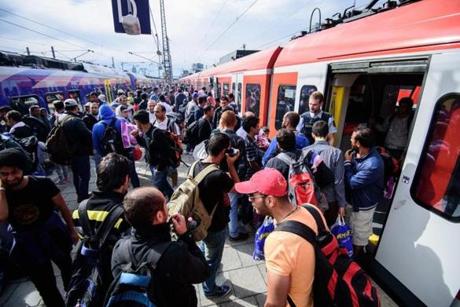Refugees boarded chartered trains after hey arrived in Munich, Germany, on Sunday.
