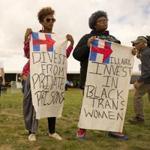 Protesters held signs as Hillary Rodham Clinton spoke in Cleveland last month.