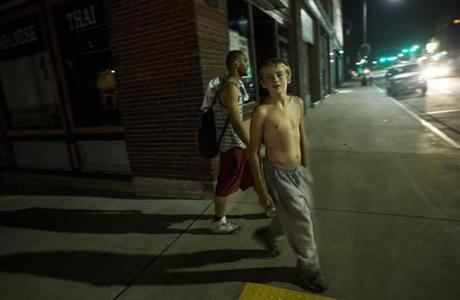 Dylan Kyles, 15, right, and his friend Stephon Williams walked through the downtown area in Franklin, N.H., after a 9 p.m. curfew on Monday.
