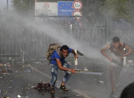 Hungarian police fired tear gas and water cannons at protesting migrants demanding they be allowed to enter from Serbia on Wednesday on the second day of a border crackdown. 
