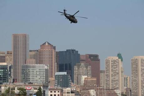 A Blackhawk helicopter flew with the Boston skyline in the background early Wednesday.
