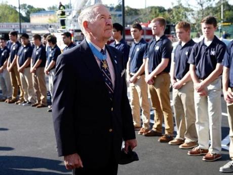 Medal of Honor recipient and Vietnam veteran Walter Marm, Jr. paused at the entrance of Malden Catholic High School.  

