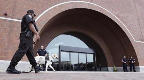 An explosives detection canine and Department of Homeland Security officers man their posts outside the Moakley Federal Courthouse as inside jury deliberations continue in the penalty phase of the trial of Boston Marathon bomber Dzhokhar Tsarnaev, Friday, May 15, 2015. The federal jury must decide whether the 21-year-old Tsarnaev should be sentenced to death or life in prison for his role in the deadly 2013 attack. (AP Photo/Charles Krupa)
