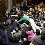 Opposition lawmakers surged toward Japanese Parliament?s chairman, as ruling party members moved to protect him.