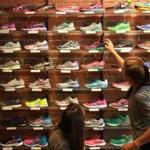 Customer service is a big selling point for stores like Marathon Sports on Boylston Street, where Lauren Roth helped fit customers trying on running shoes. 