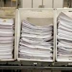 A stack of tax-related paperwork awaited sorting at the Data Integration Bureau of the state Department of Revenue.