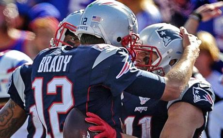 Patriots quarterback Tom Brady (left) and wide receiver Julian Edelman celebrated after a third-quarter touchdown.
