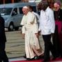 Pope Francis (center) walking at Antonio Maceo international airport upon his arrival in Santiago de Cuba. 