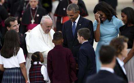 Pope Francis greets onlookers as he was escorted by President Obama after arriving at Andrews Air Force Base in Maryland. 
