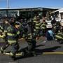 Emergency personnel worked at the scene of a fatal collision involving a charter bus and a 