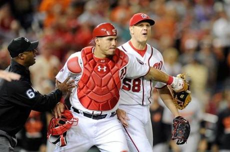 WASHINGTON, DC - SEPTEMBER 23: Jonathan Papelbon #58 of the Washington Nationals is restrained by Wilson Ramos #40 after being thrown out of the game in the ninth inning against the Baltimore Orioles at Nationals Park on September 23, 2015 in Washington, DC. (Photo by Greg Fiume/Getty Images)
