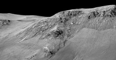 A handout image made available by NASA shows dark, narrow, 100 meter-long streaks called recurring slope lineae flowing downhill on Mars that are inferred to have been formed by contemporary flowing water.
