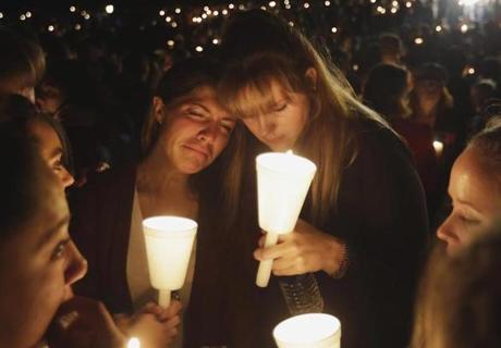 Kristen Sterner, left, and Carrissa Welding, both students of Umpqua Community College, embrace each other during a candle light vigil for those killed during a fatal shooting at the college, Thursday, Oct. 1, 2015, in Roseburg, Ore. (AP Photo/)
