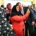 Mayor Walsh snapped a selfie (top) and spoke to worshipers at the Islamic Society of Boston Cultural Center.