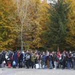 A group of migrants waited to be registered as they prepared to cross the border into Spielfeld in Austria from the village of Sentilj, Slovenia.