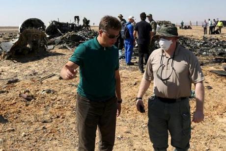 Russian Transport Minister Maxim Sokolov (L) speaks with a military investigator at the crash site of a Russian airliner in the al-Hasanah area in El Arish city, north Egypt, November 1, 2015. Russia has grounded Airbus A321 jets flown by the Kogalymavia airline, Interfax news agency reported on Sunday, after one of its fleet crashed in Egypt's Sinai Peninsula, killing all 224 people on board. REUTERS/Mohamed Abd El Ghany

