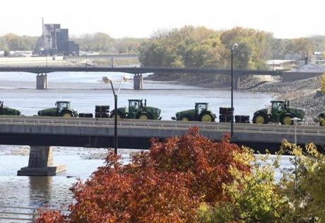 WATERLOO, IA - OCTOBER 14: John Deere tractors are transported by rail across the Cedar River, on October 14, 2015, in Waterloo, Iowa. (Matthew Holst for the Boston Globe)
