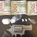 Boston police seized a gun, suspected crack cocaine, and more than $6,000.