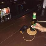 A ChefCharger coaster charged a smartphone on a bar top.