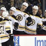 Boston Bruins Ryan Spooner (51) is congratulated by teammates after scoring a goal against the New York Islanders during the first period of an NHL hockey game on Sunday, Nov. 8, 2015, in New York. (AP Photo/Kathy Kmonicek) 