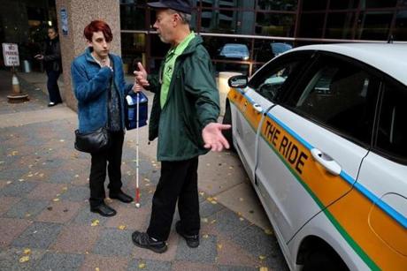 Passenger Mandi Curtis, of Roxbury, talked with The Ride driver Manny Rebello outside Boston Medical Center.
