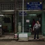 A police officer talked on the phone outside a police station in Yangon, Myanmar, on Tuesday. After the opposition?s election victory, police are still under the military?s control. 