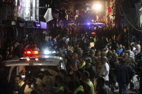 Lebanese security personnel and citizens gathered at the scene of a twin suicide bombing that rocked a busy shopping street in an area called Burj al-Barajneh.
