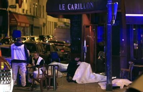 Victims lay on the pavement by a Paris restaurant. 
