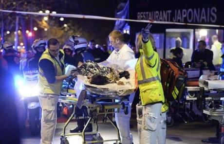 Rescuers evacuated an injured person near the Bataclan concert hall.
