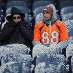 Fans waited in the snow covered seats before an NFL football game between the Chicago Bears and the Denver Broncos. 