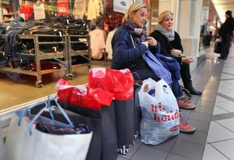 Constanze Nied (left) and her friend Kirsten Friese, both from Germany, took a rest during Black Friday shopping at the Cambridgeside Galleria in 2014. 
