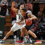 Miami guard Angel Rodriguez (13) tries to block the path of Northeastern's T.J Williams during the first half of an NCAA college basketball game in Coral Gables, Fla., Friday, Nov. 27, 2015. Northeastern won 78-77. (AP Photo/Gaston De Cardenas)