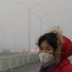 A woman wore a face mask as she walked in fog- and pollution-clouded Beijing.