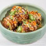Chicken and quinoa meatballs at Yvonne?s are accompanied by Chinese garlic sauce, spicy mayonnaise, peanuts, sesame seeds, and herbs.