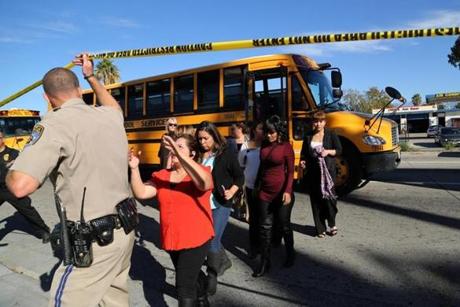 Employees and other people were evacuated by bus from the site of a mass shooting at the Inland Regional Center. 
