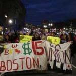 In November, protesters chanted as they marched towards the State House during a rally for minimum-wage workers who were seeking a raise to $15 per hour in Boston.