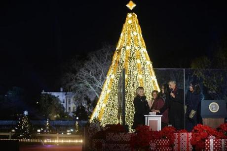 Actress Reese Witherspoon, mother-in-law Marian Robinson, Malia Obama, President Barack Obama and first lady Michelle Obama attended the national Christmas tree lighting ceremony on the Ellipse south of the White House . 
