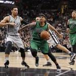 Celtics guard Isaiah Thomas (right) tried to drive past the Spurs? Danny Green in the first half.