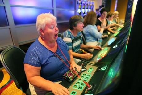 Jean DeThomas of Melrose reacted to a good slot spin after the Plainridge casino opened. Payoffs have since increased.
