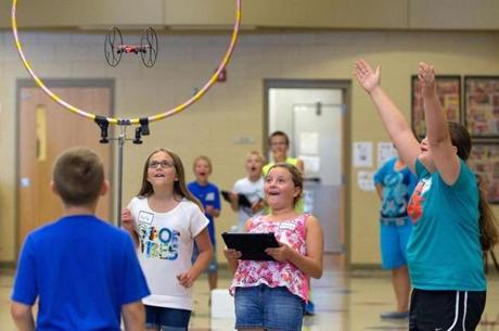 Fifth graders flew a drone through a hoop as part of an experiment in class at their elementary school in Gretna, Neb.
