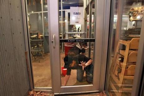 Workers cleaned the closed Chipotle Restaurant in Cleveland Circle.
