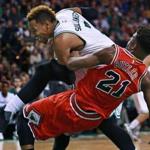 The Celtics? Jared Sullinger and Jimmy Butler of the Bulls get tangled up under the boards in the first half.