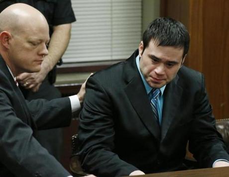 Defense attorney Robert Gray (left) placed his hand on the shoulder of defendant Daniel Holtzclaw (right) as they waited for the verdicts in his trial in Oklahoma City. 
