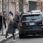 A Northeastern University officer stepped out of his police vehicle. 